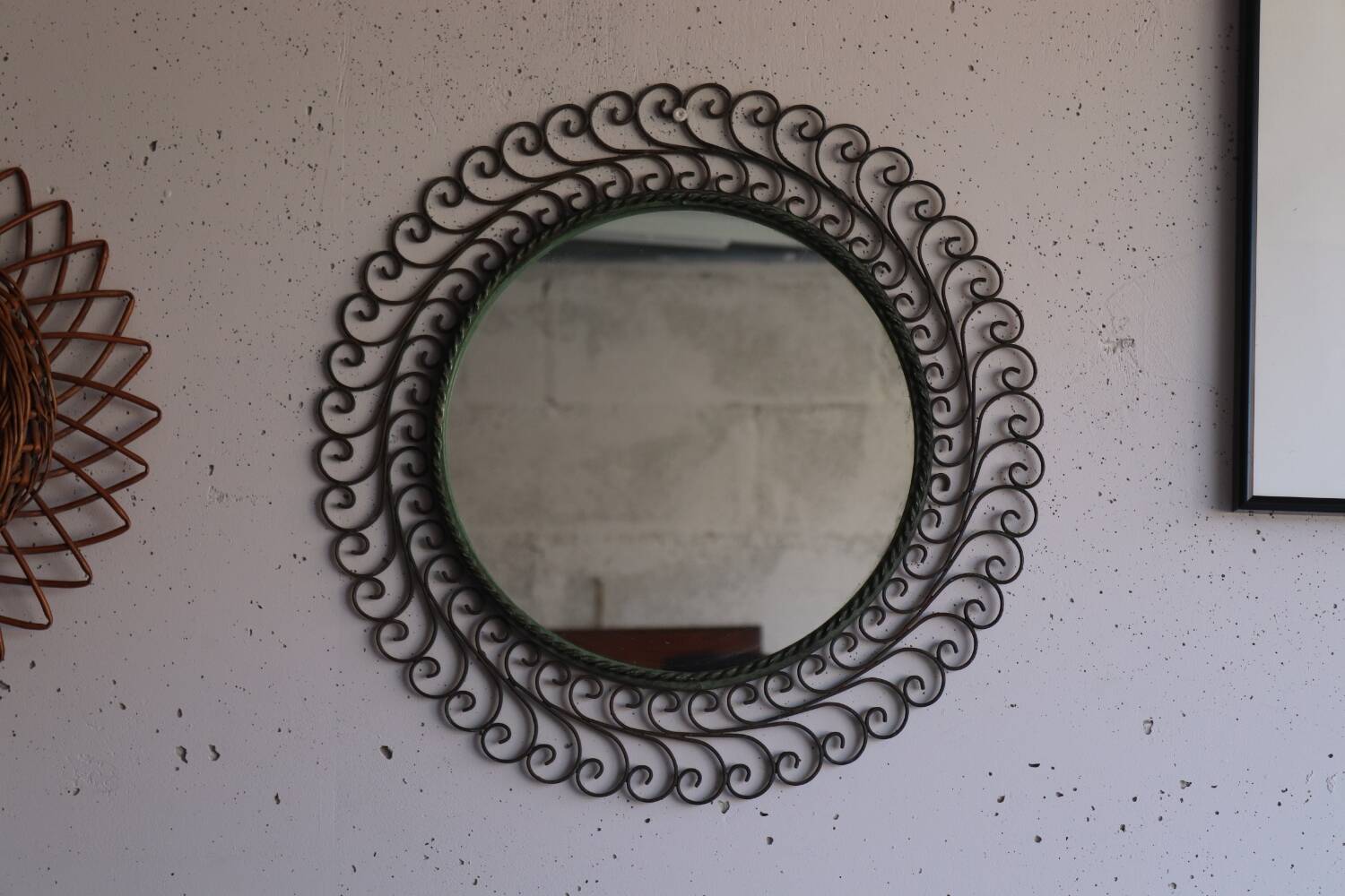 Large round vintage mirror in black metal with green patina