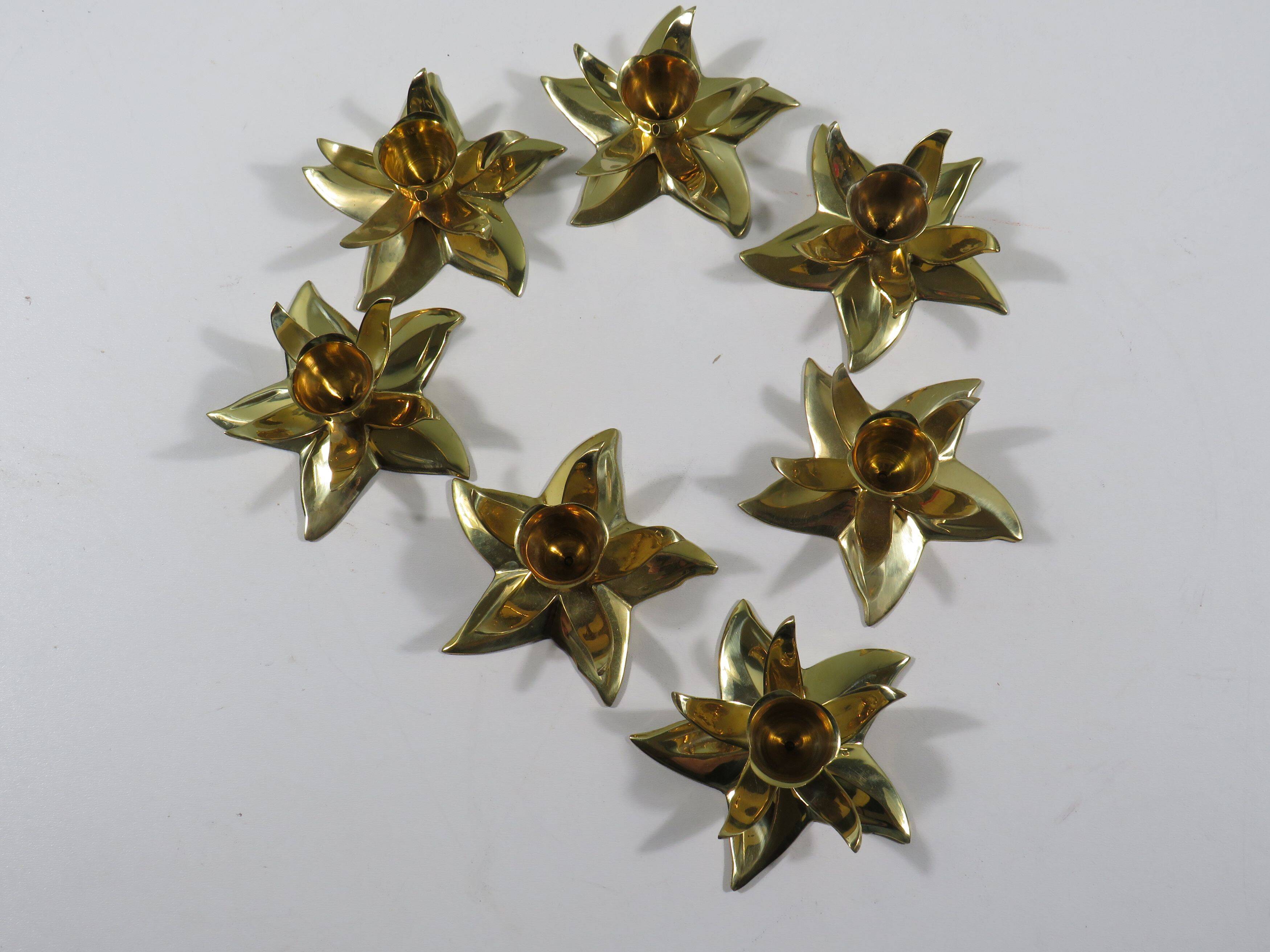 Set of 7 heavy shiny brass flower shaped candle holders, 1970-1980