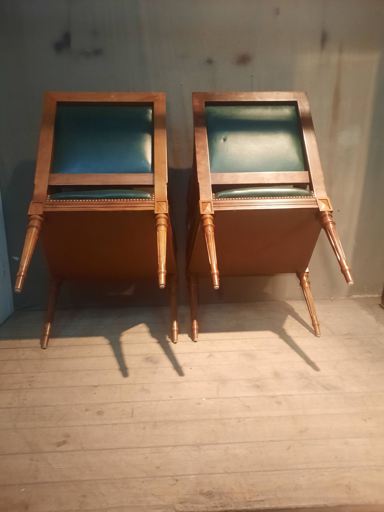 Pair of Louis XVI style armchairs upholstered in green leather.