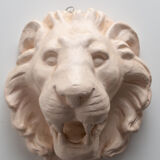 Lion's head in painted plaster