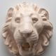 Lion's head in painted plaster