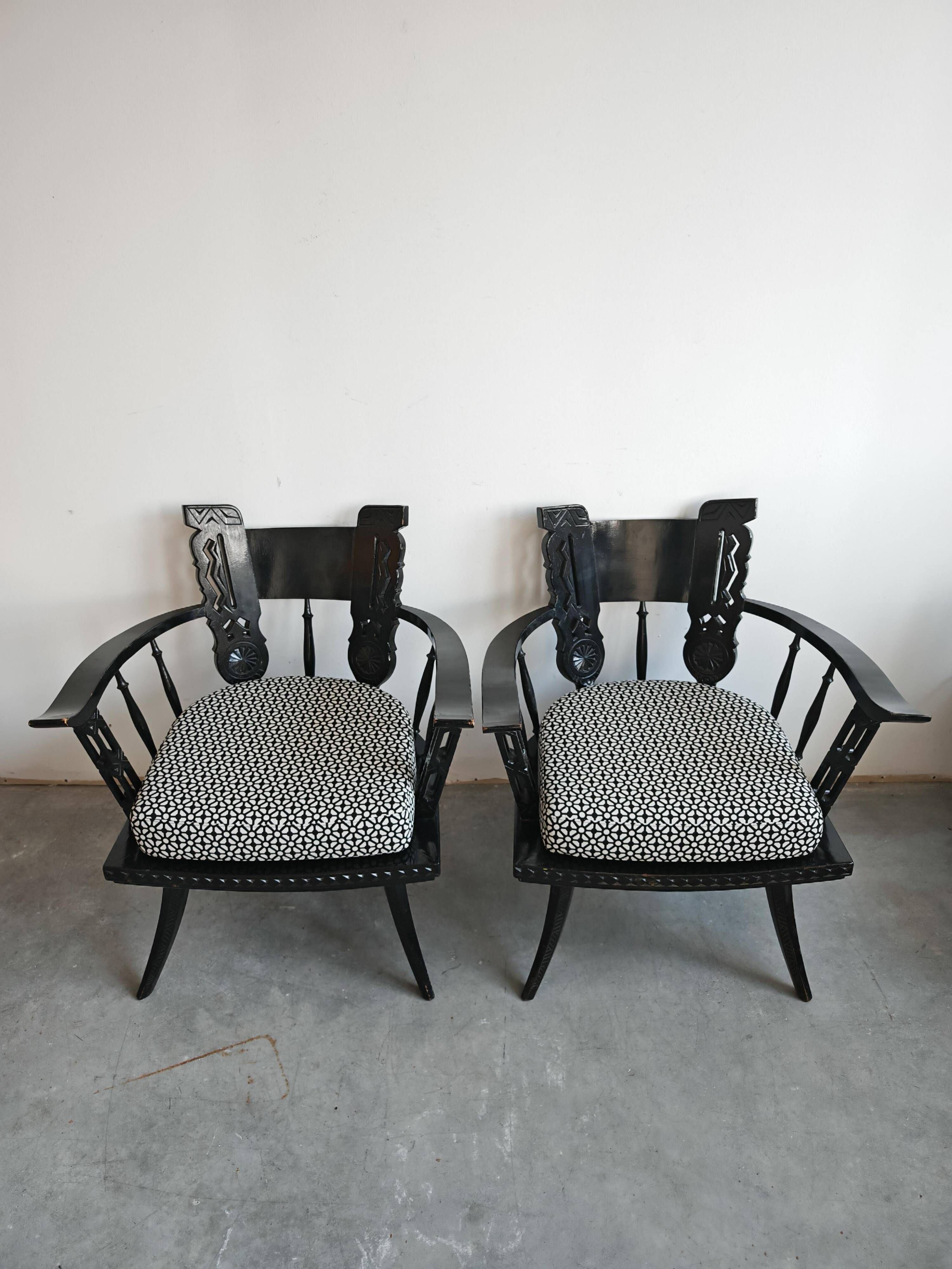 Pair of antique hand-carved armchairs in black lacquer from the 1920s.