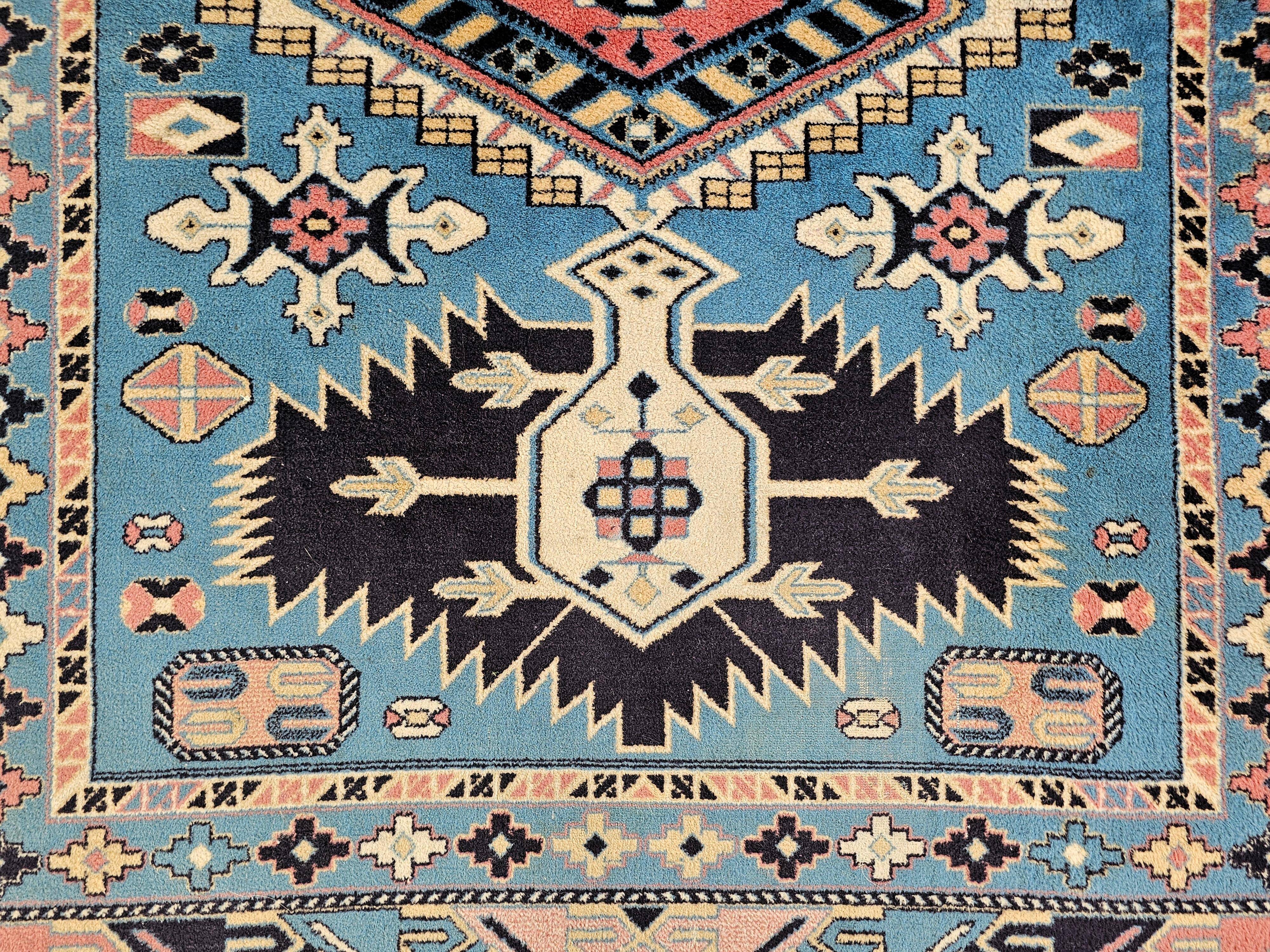 Vintage Kazak rug with geometric oriental motifs, 100% wool.