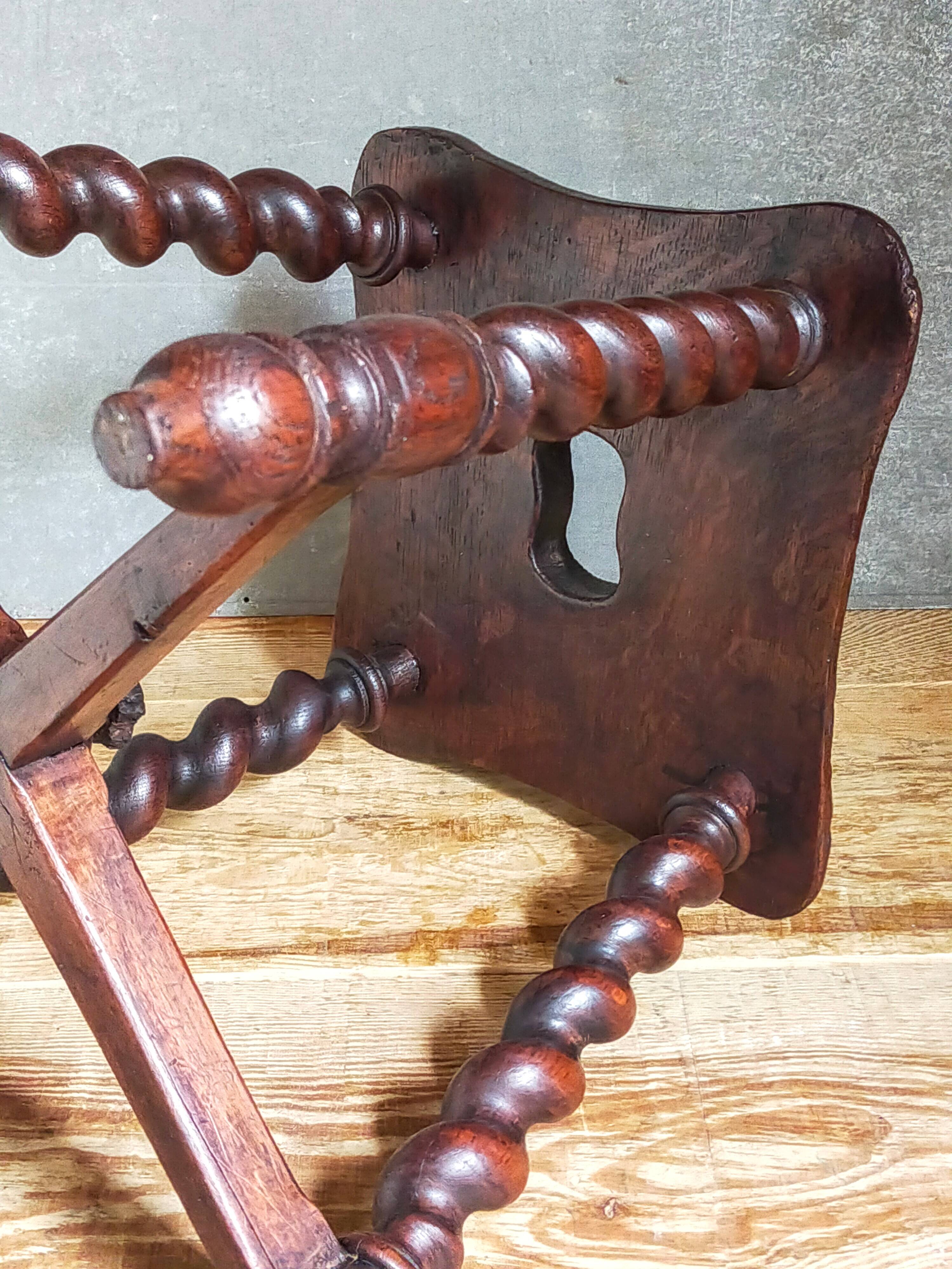 Antique stool in turned and carved solid wood