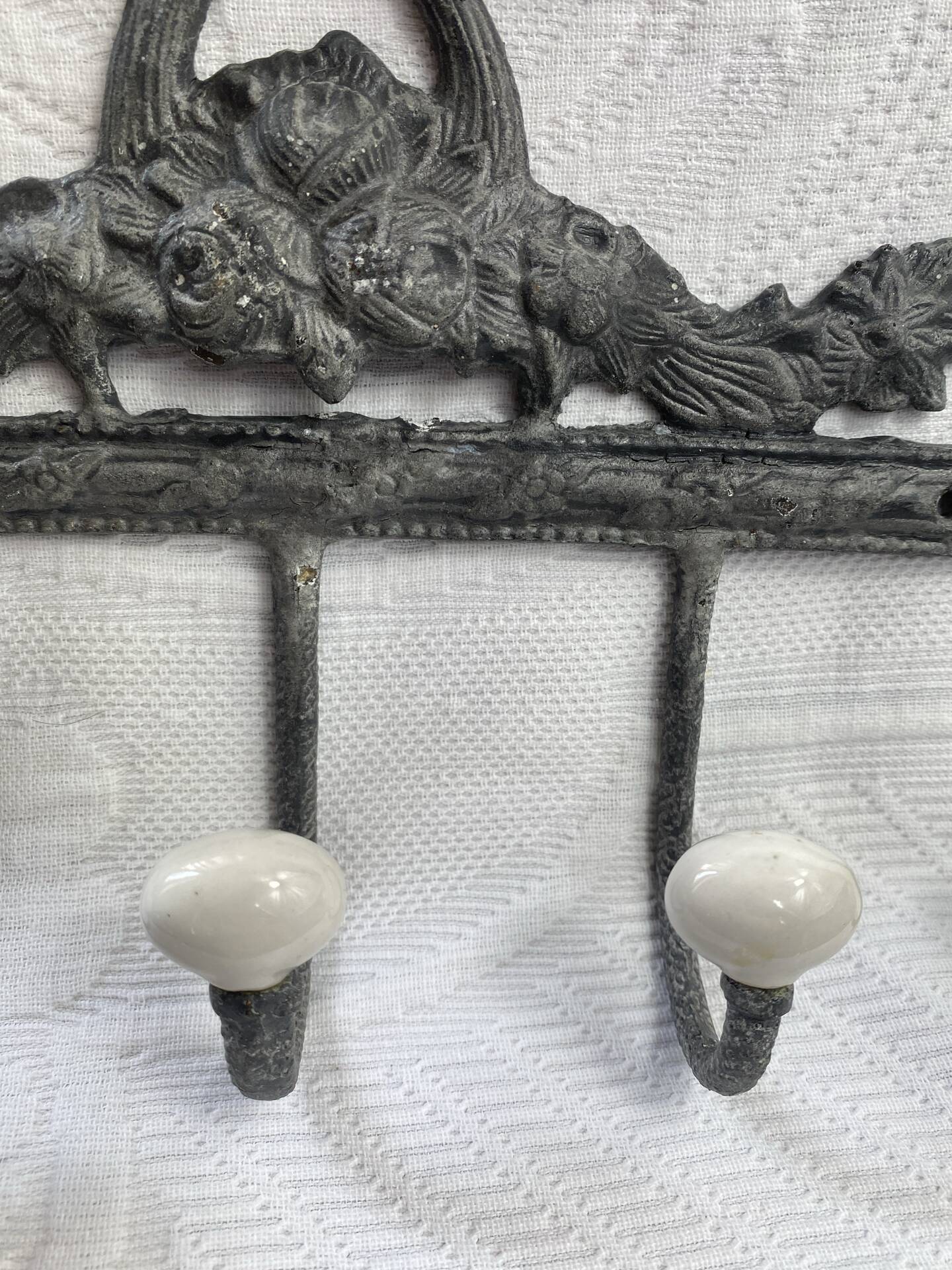 Patinated metal wall bracket and porcelain