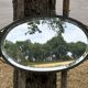 Bevelled oval mirror, richly crafted Art Deco wrought iron.