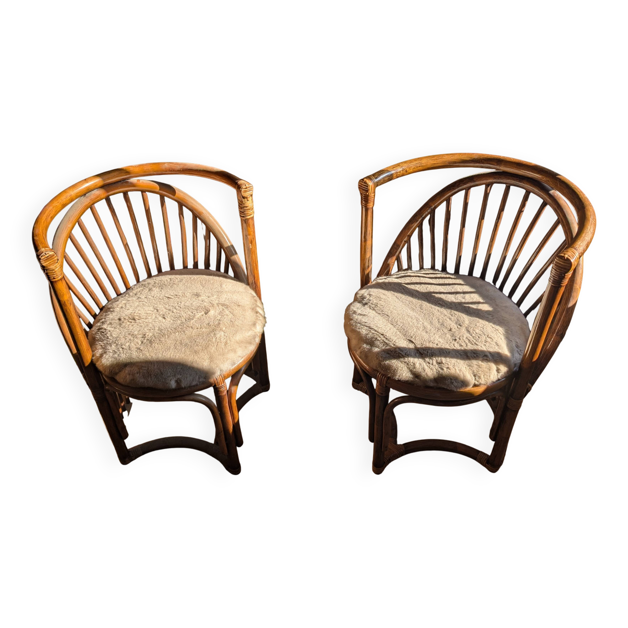 Pair of vintage rattan armchairs with soft fabric seats