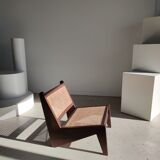 Reclined armchair in canned teak in natural wood