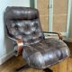 1970s Scandinavian armchair in curved laminated wood with a leather seat.