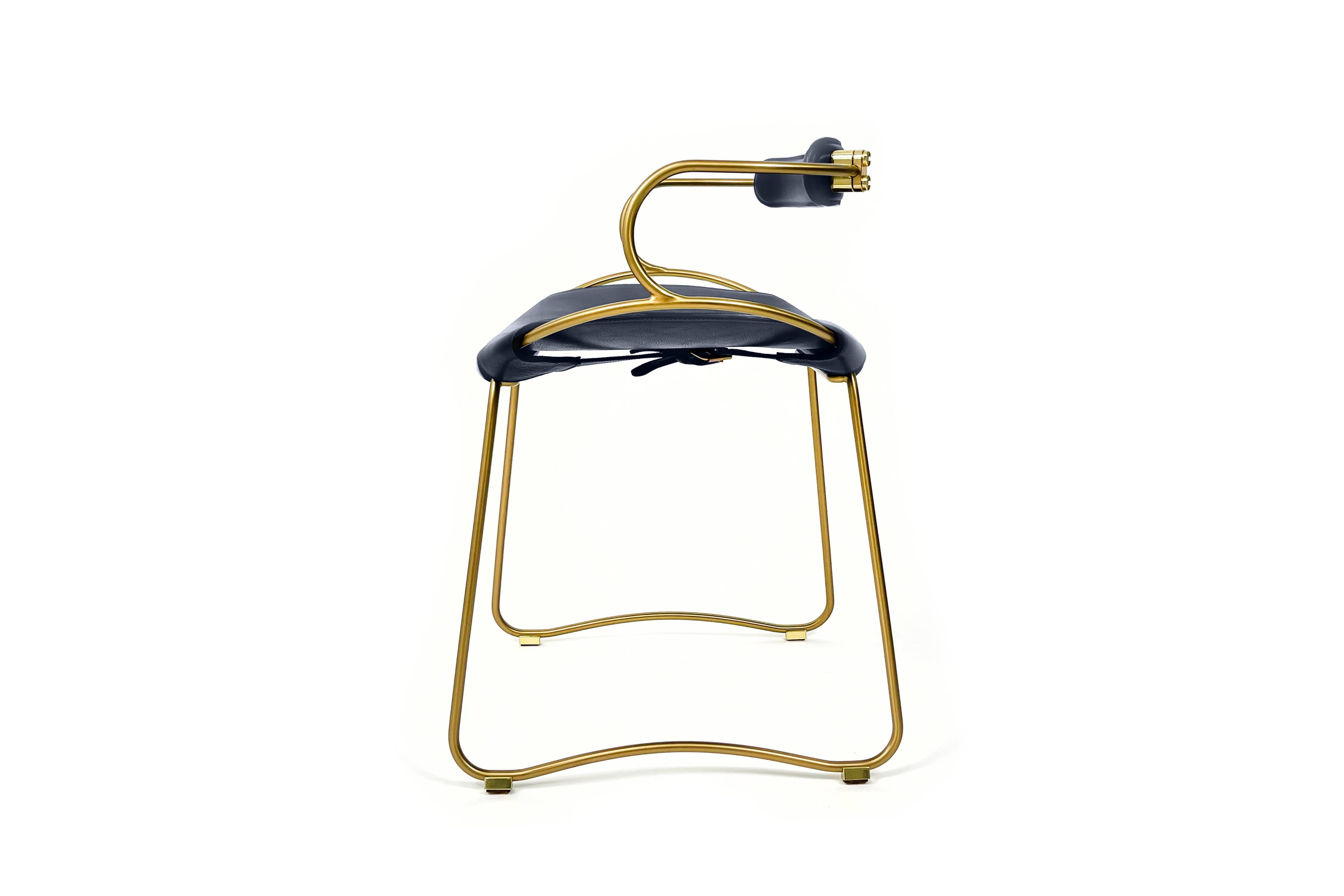 Contemporary kitchen bar stool with brass metal backrest and navy blue leather.