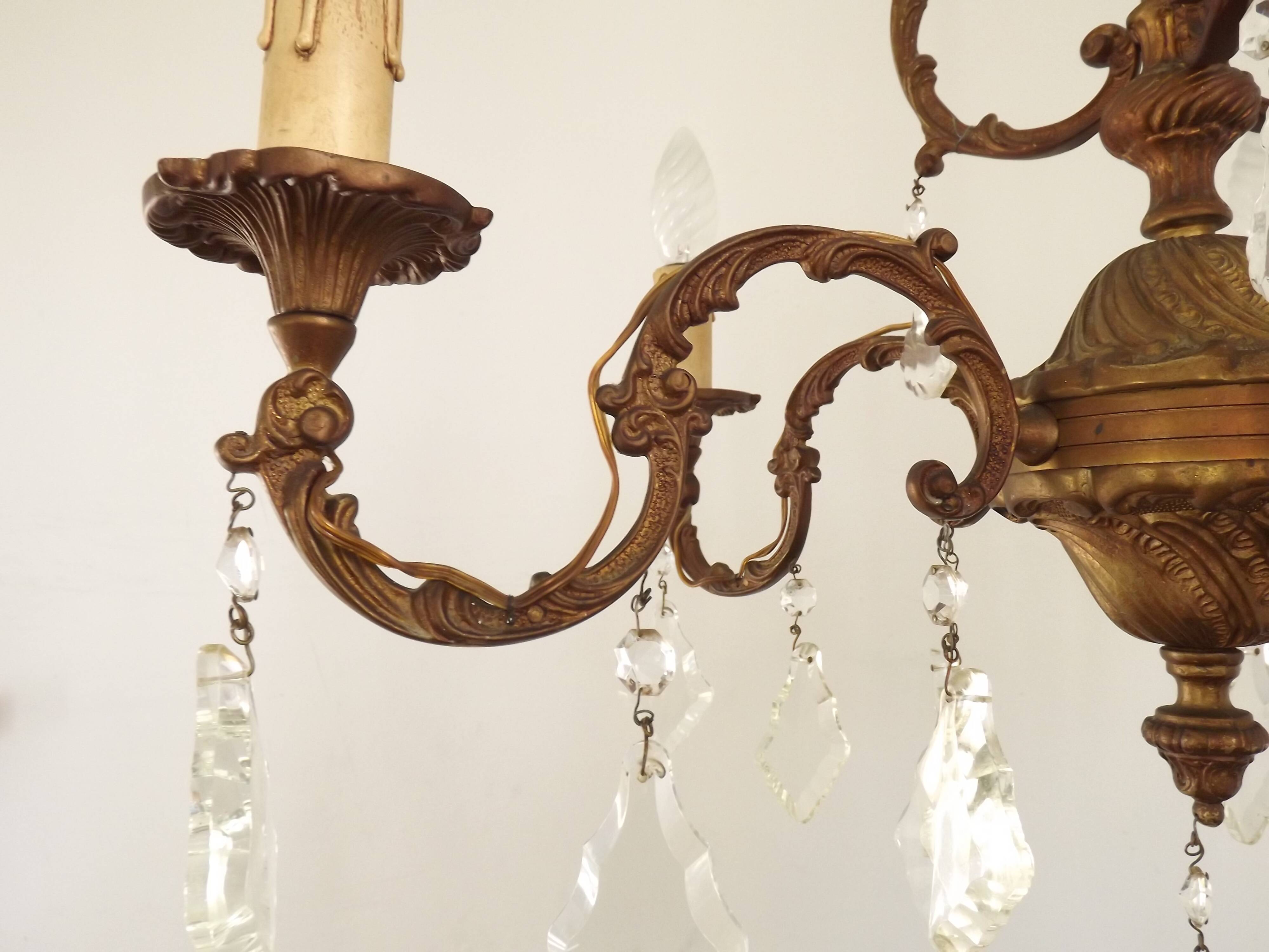 Antique French bronze chandelier with 6 lights and matching crystals.