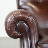 Comfortable and correct dark antique sheepskin English armchair in very good condition