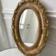 Miroir ovale médaillon en stuc doré années 70