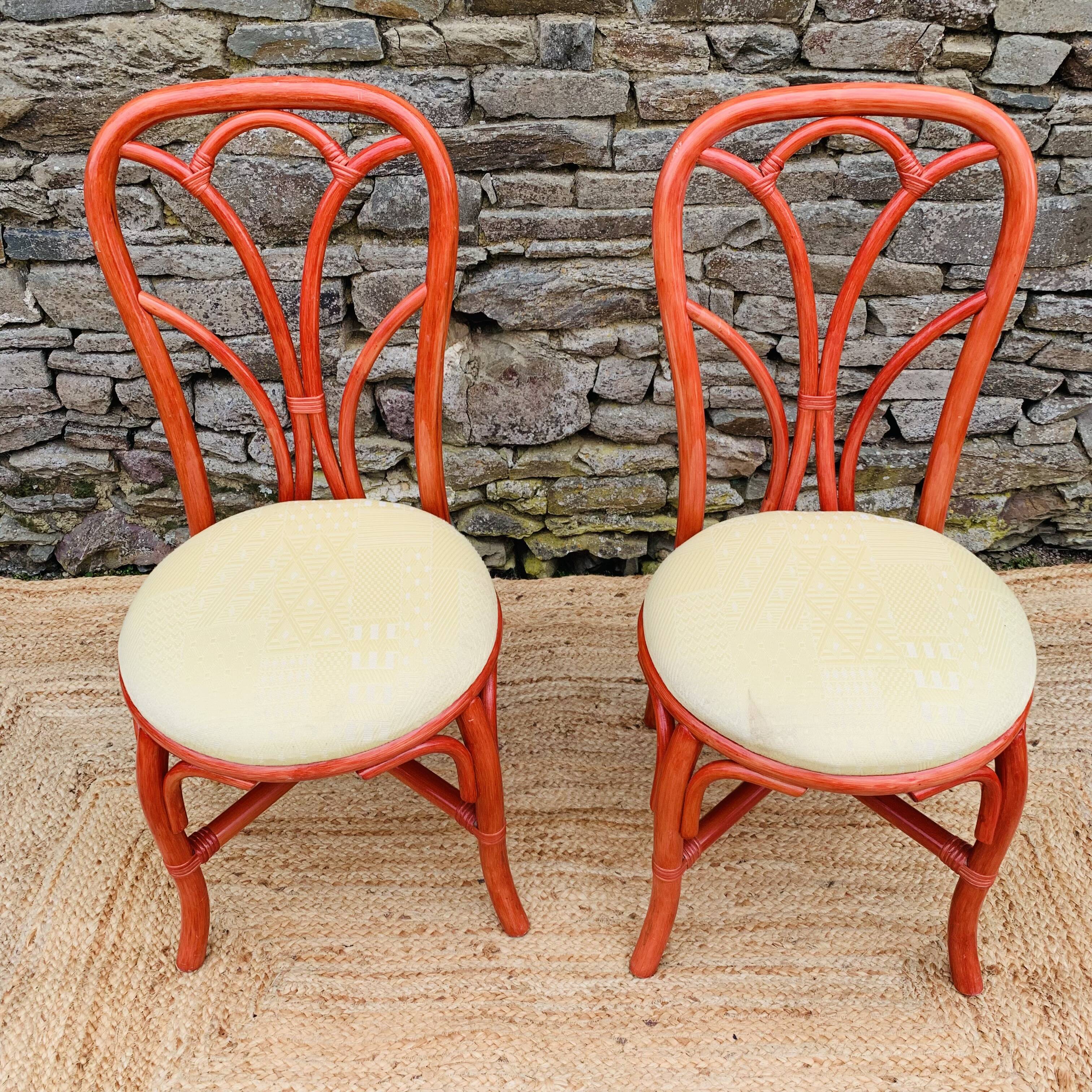 Pair of red rattan chairs and fabric