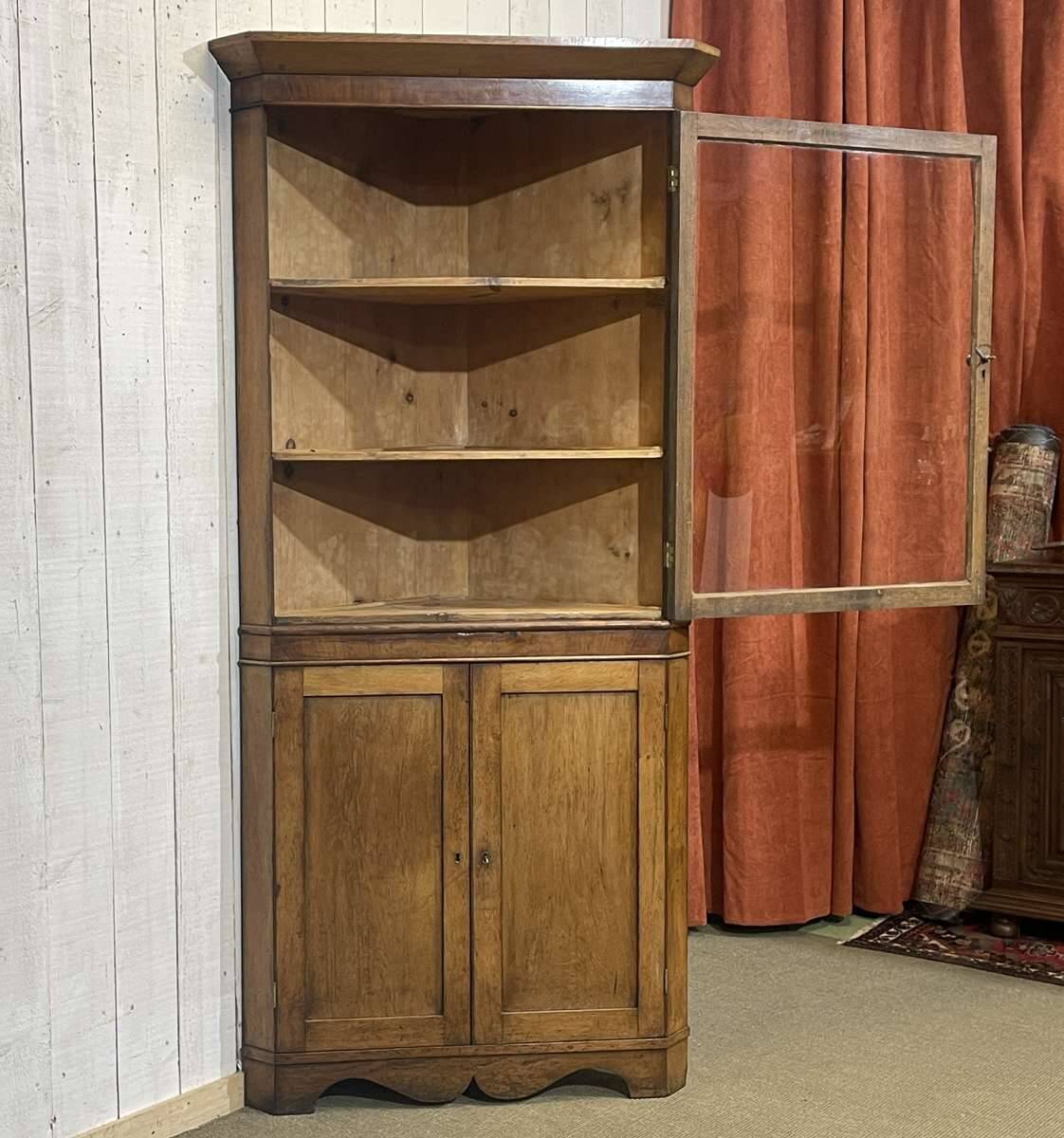 19th-century English corner cabinet in oak, mahogany, and fir.