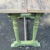 Old table with patinated green legs
