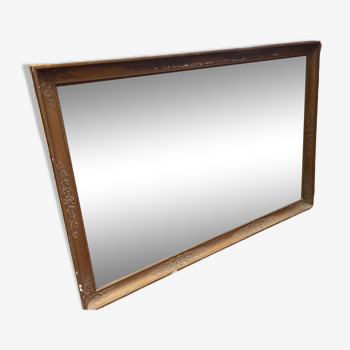 Large patinated mirror with gilded frame