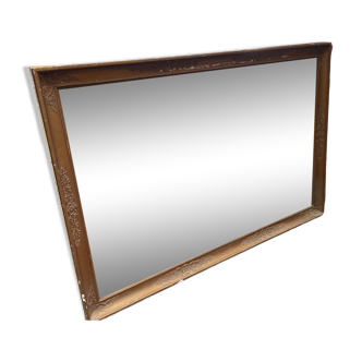 Large patinated mirror with gilded frame