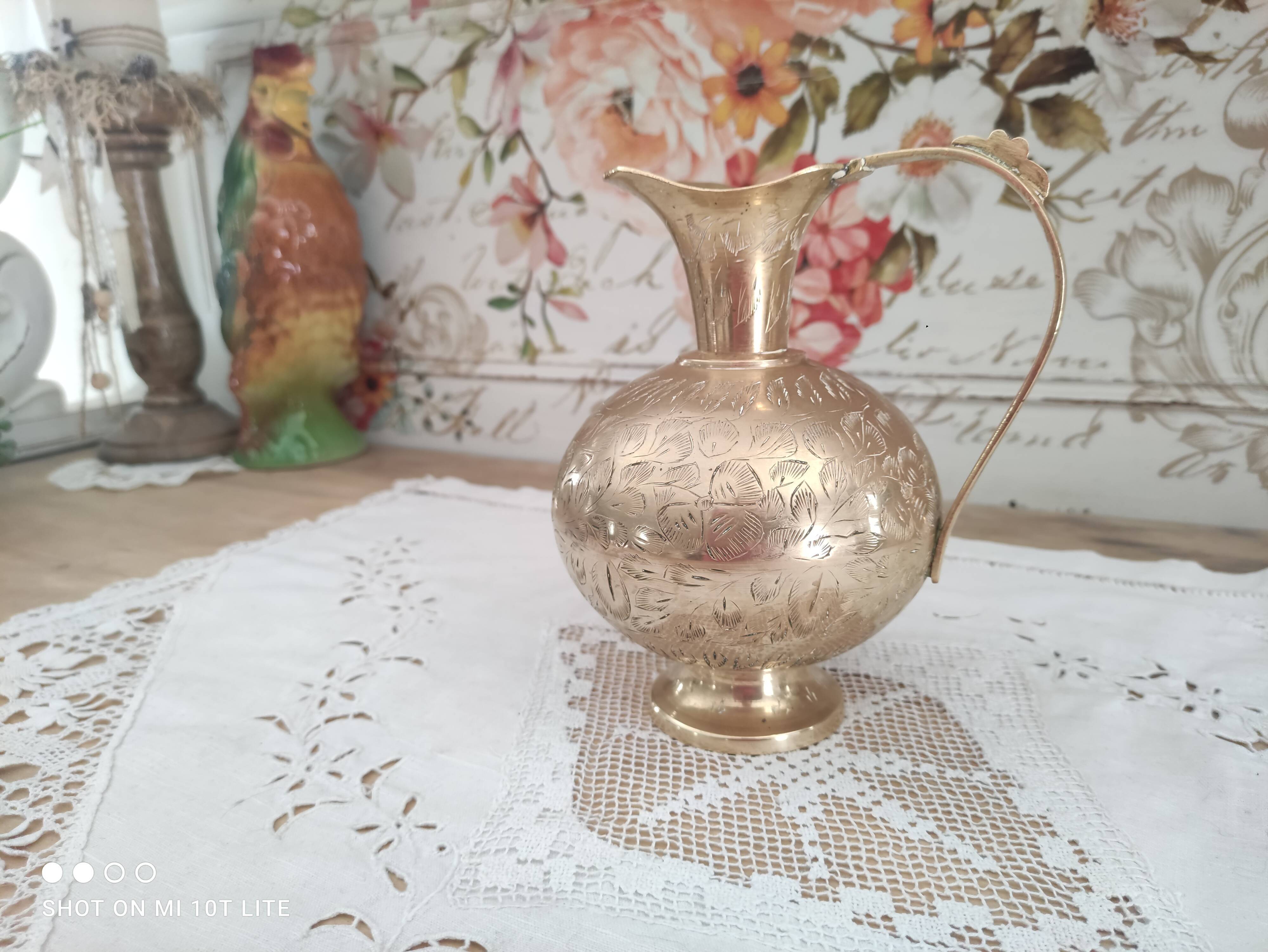 Chiseled brass pitcher decorated foliage