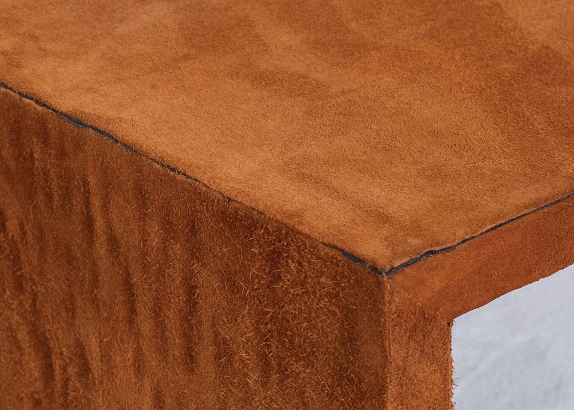 Pair of cognac suede side tables in the style of Jean Michel Frank.