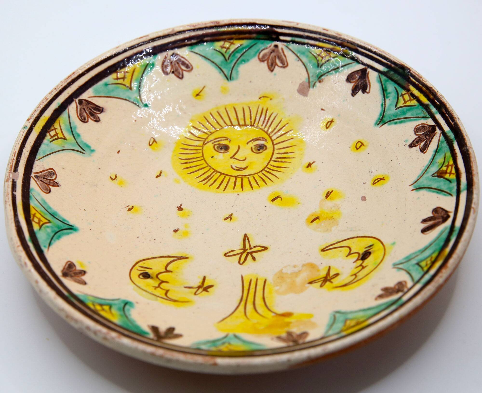 Handmade plate with moon and sun in Romania