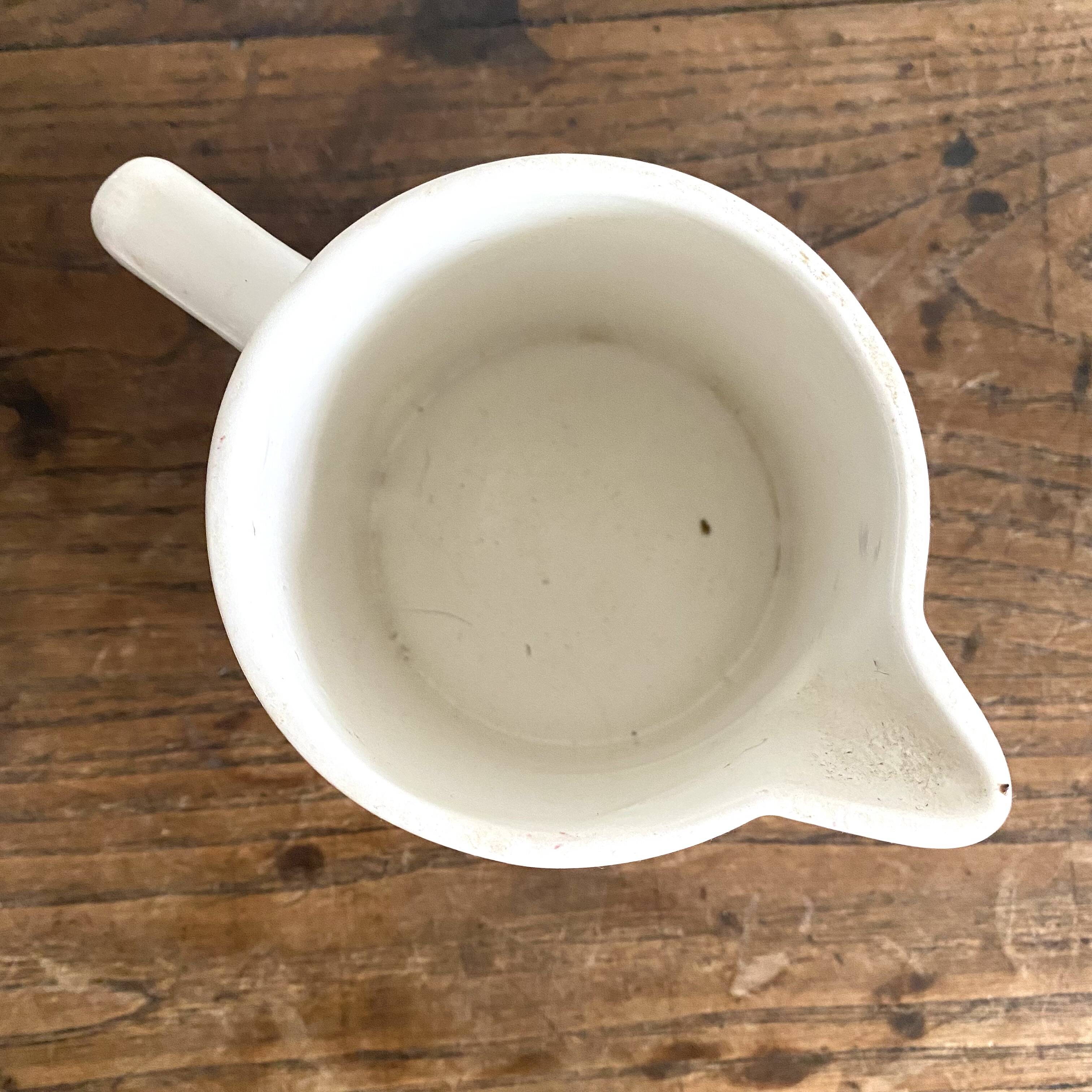Antique earthenware pitcher with burgundy stripes