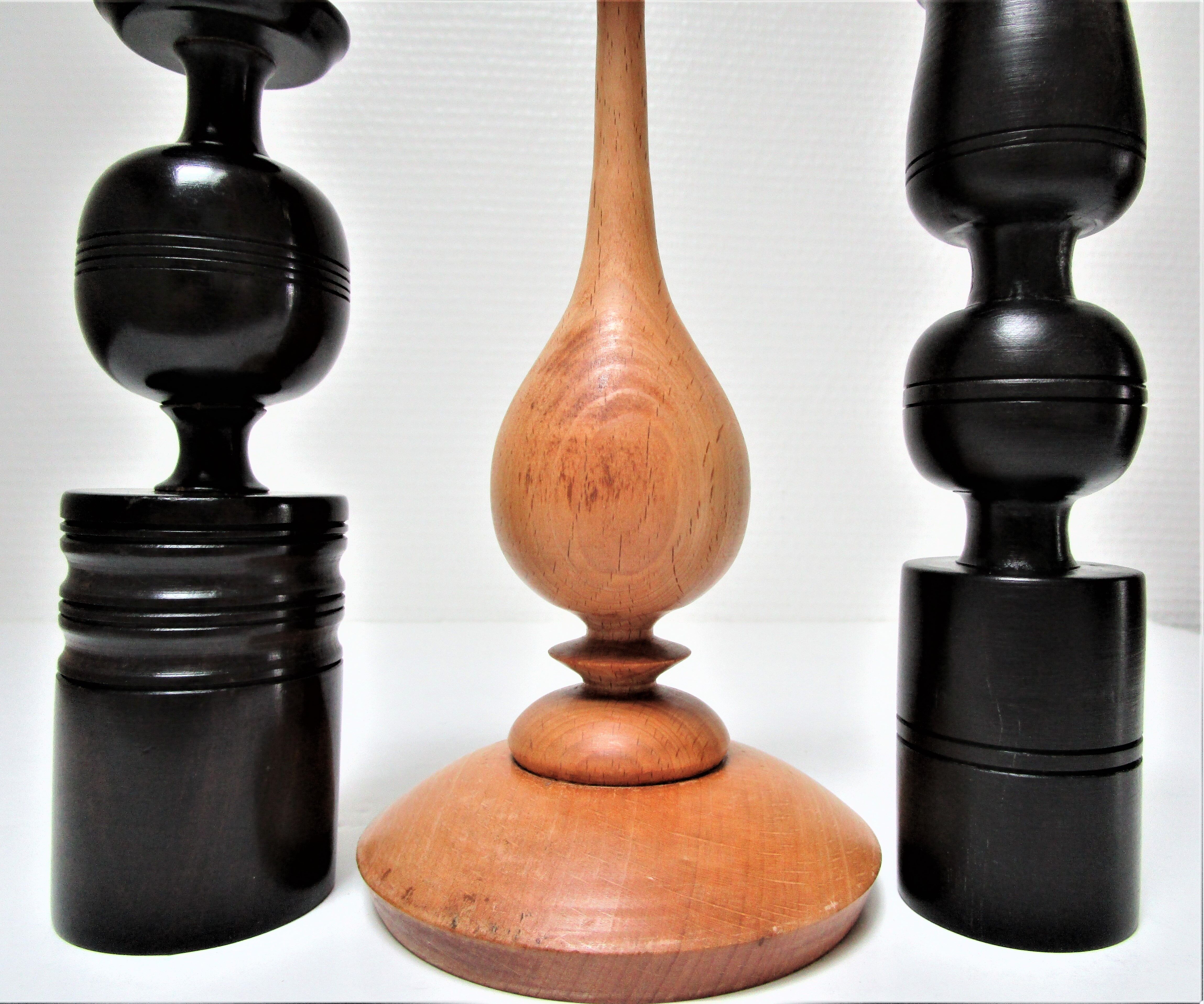 Three vintage light and dark wood candlesticks