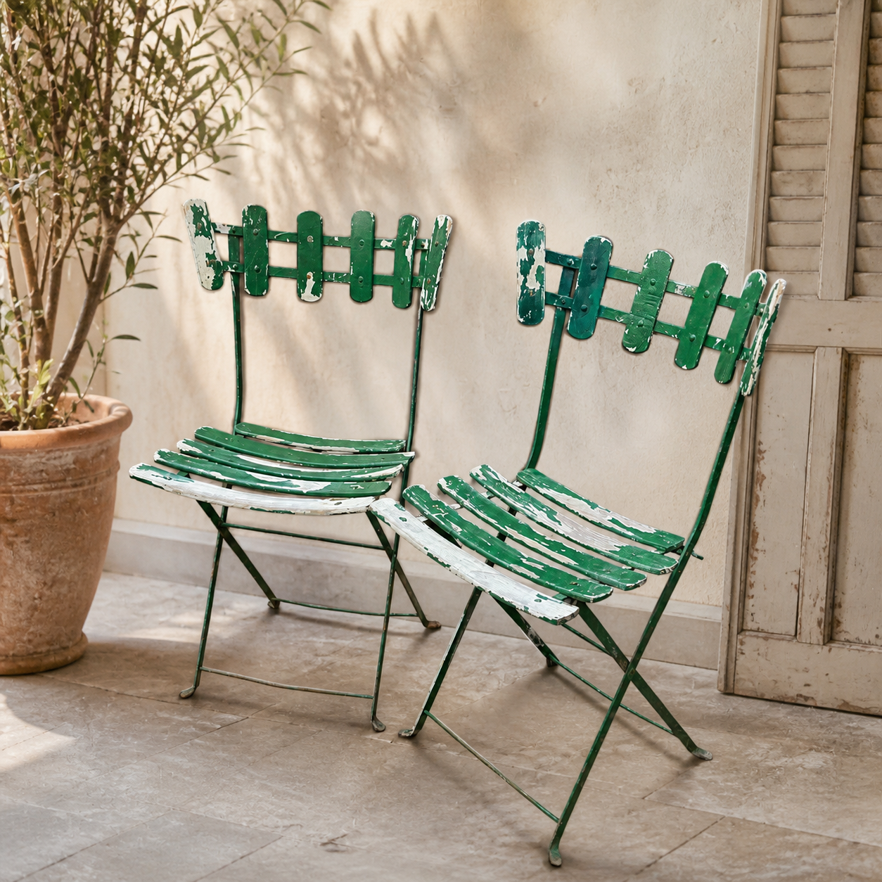 Pair of original patinated folding Parisian bistro chairs.