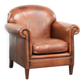 Comfortable vintage sheepskin armchair finished with decorative nails