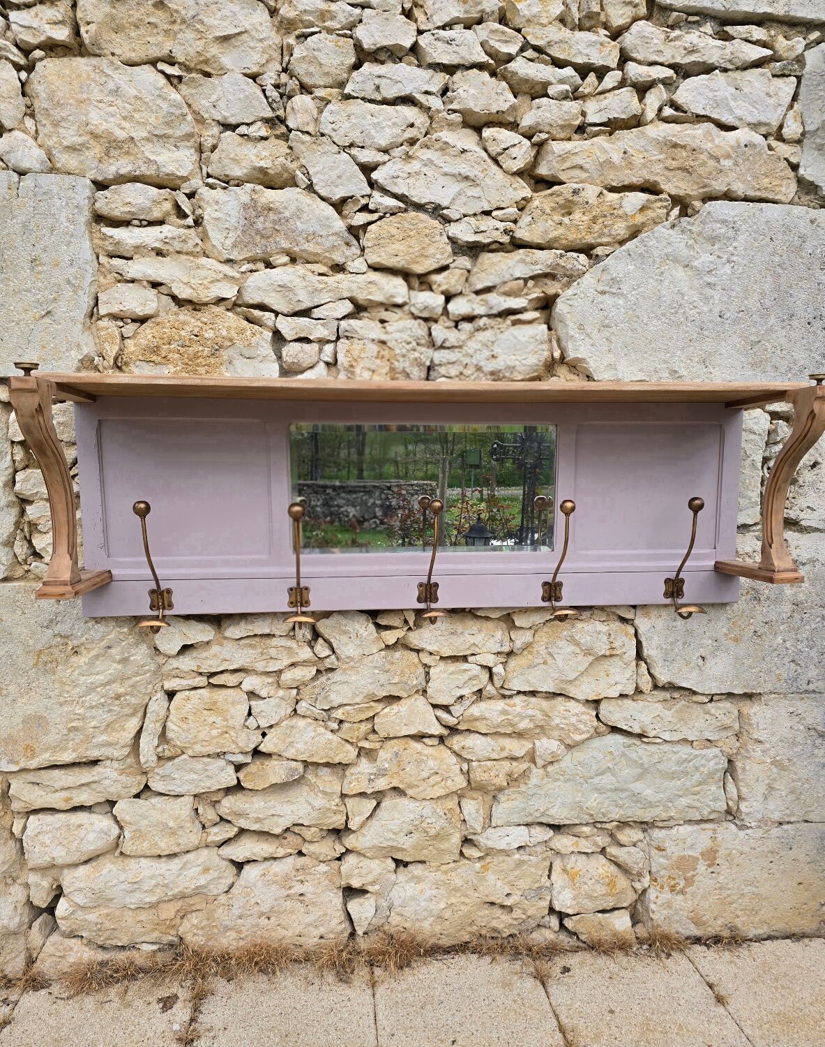 Coat rack or wall-mounted entrance wardrobe with scroll arms and antique hooks.