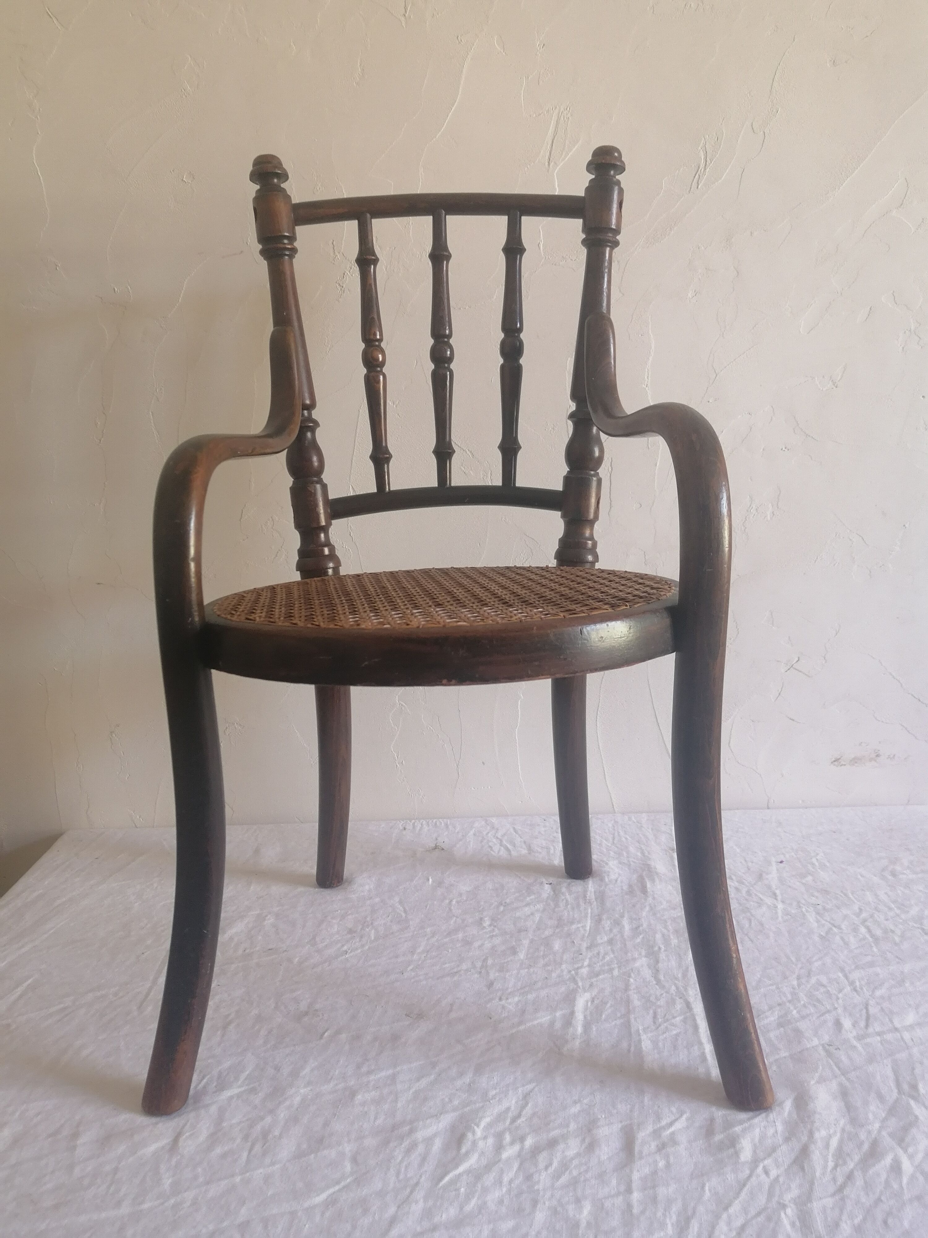 Old children's armchair in curved wood. Fischel