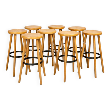 8 mid-century modern bar stools in beech and hammered iron.