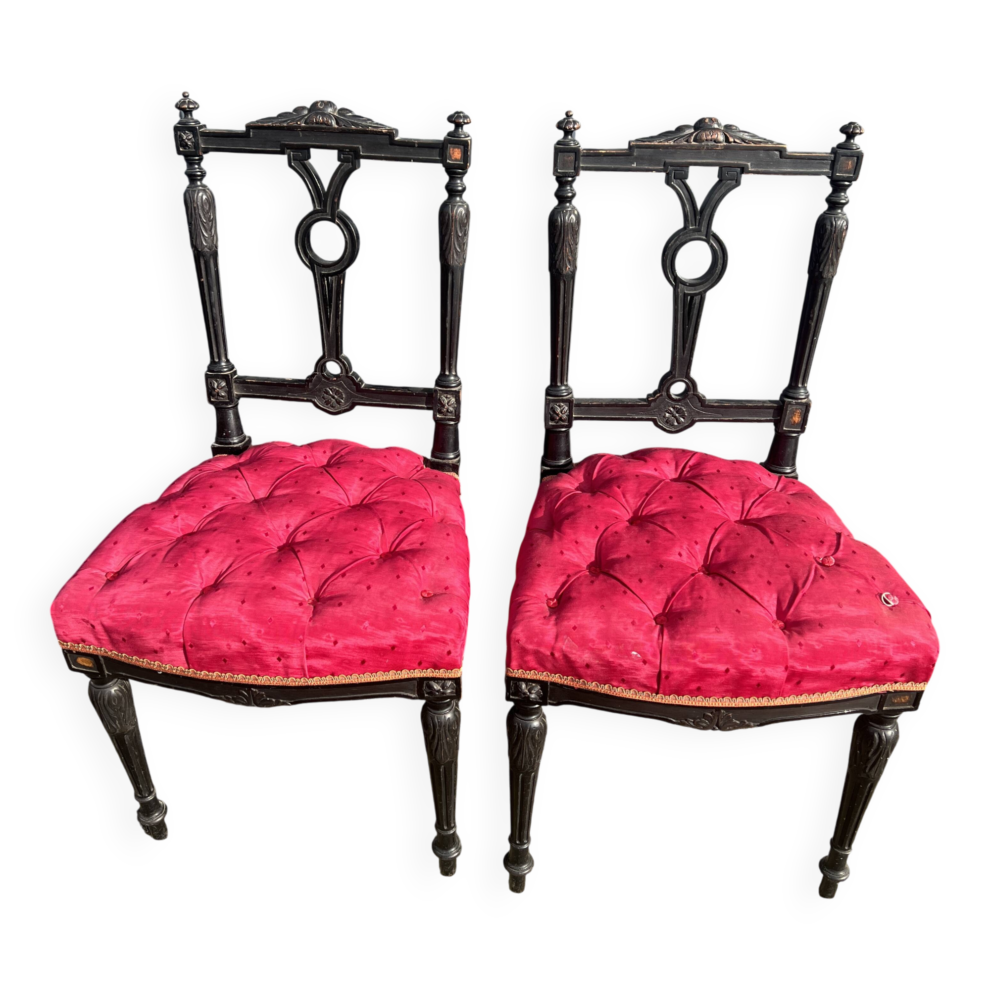 Pair of black lacquered chairs with purple tufted upholstery.