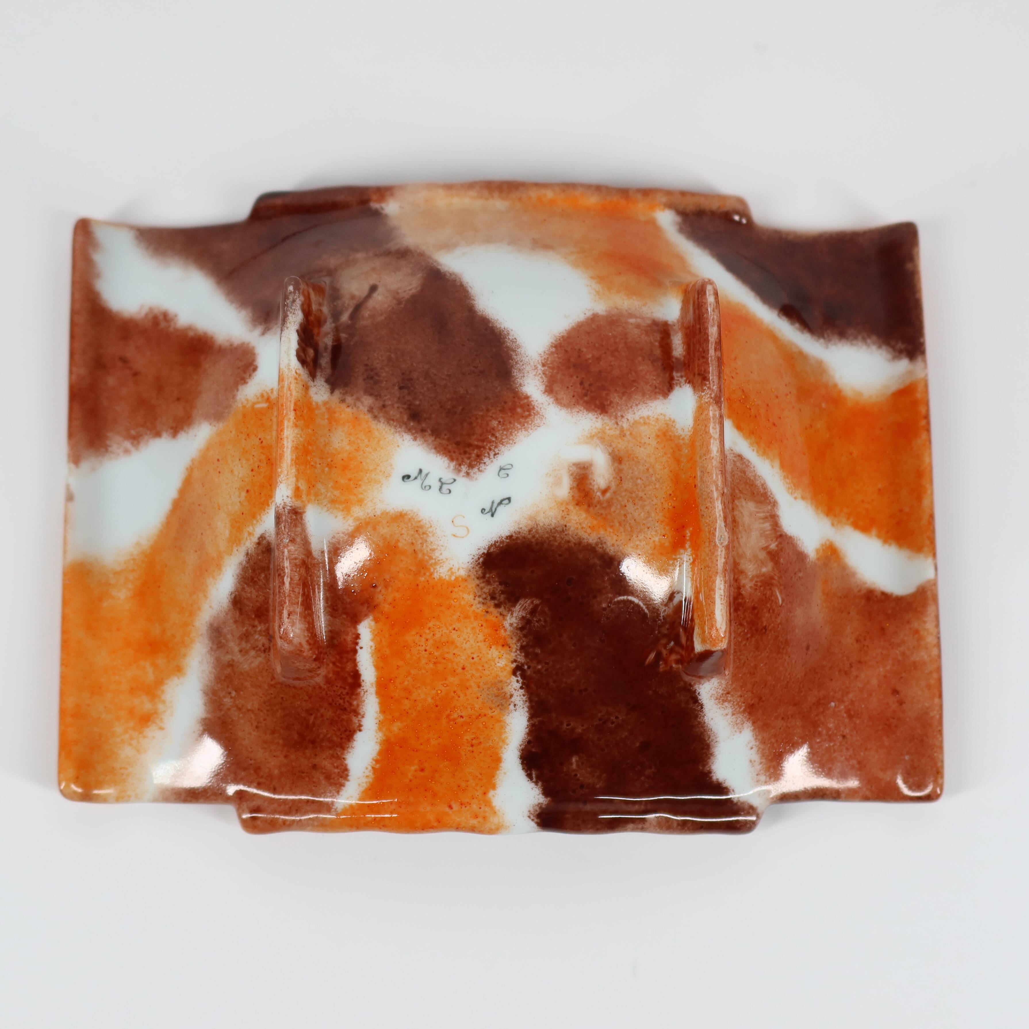 Handcrafted ceramic trinket dish in shades of brown and orange