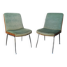 Shell chairs and green fabric