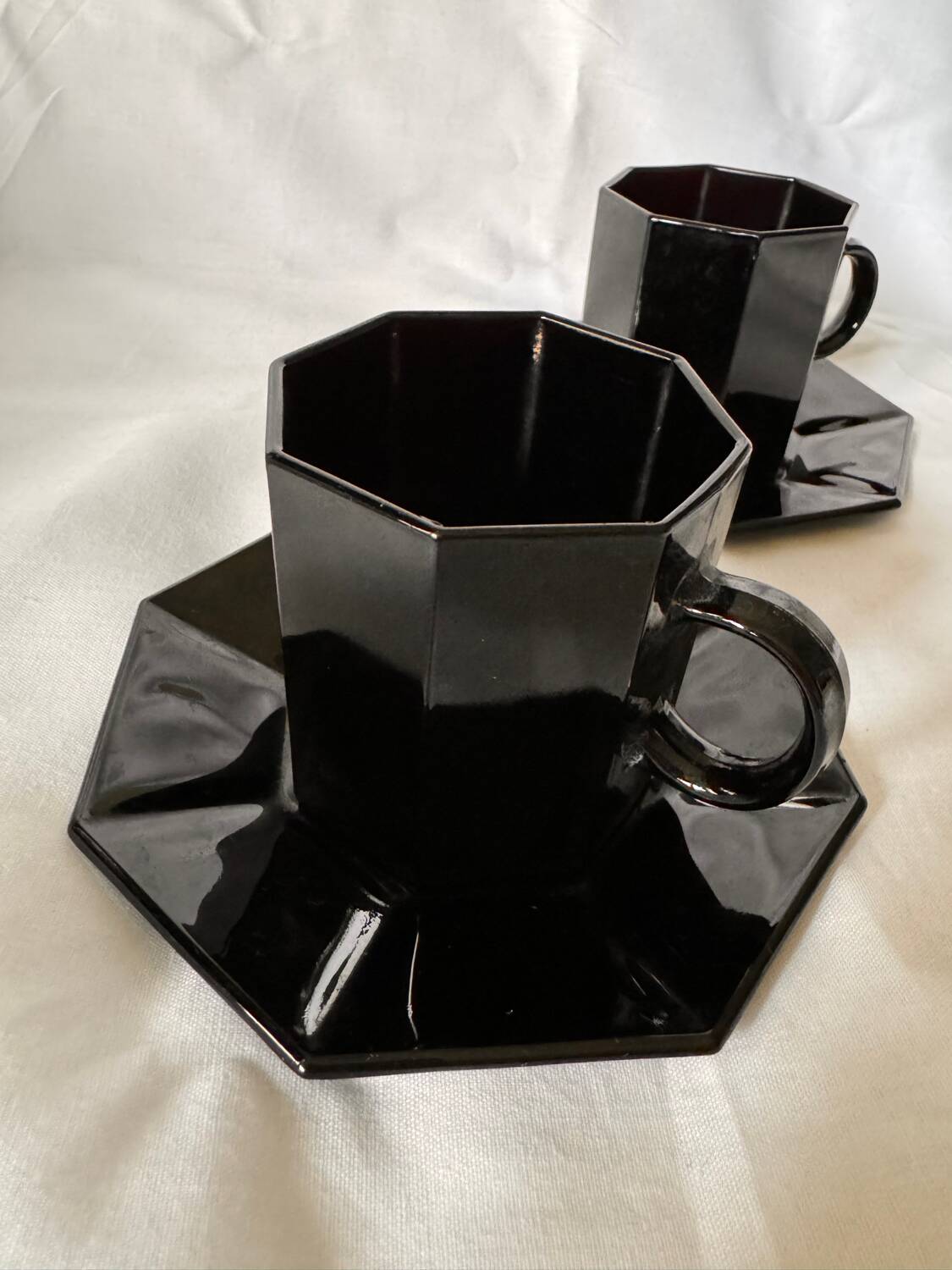 Set of 2 arcoroc black glass coffee cups with underplates