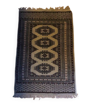 Vintage rug with oriental and geometric patterns, fringes, 63 × 90 cm