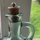 Green pitcher made of vintage glass
