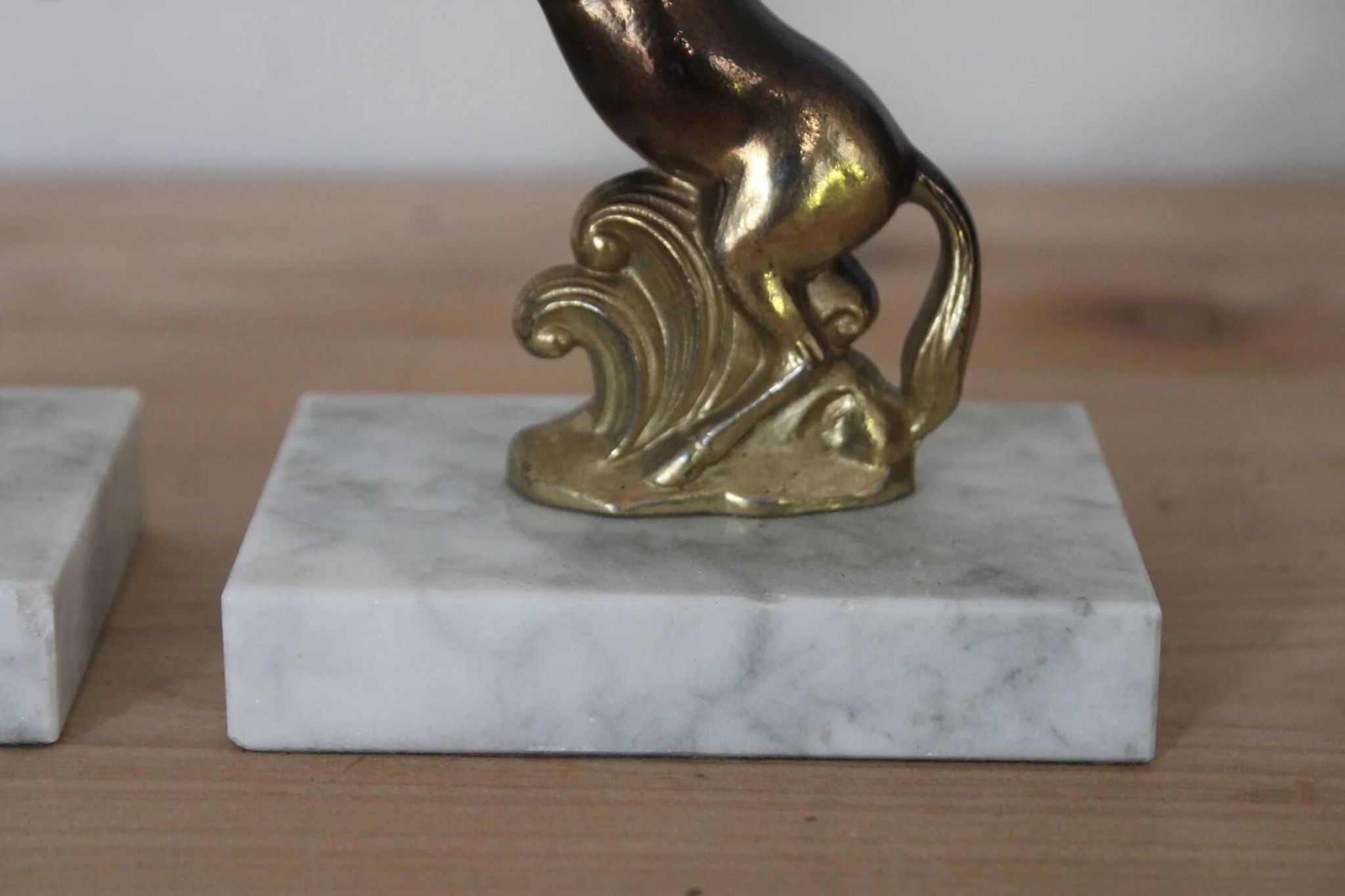 Pair of vintage bookends with rearing horses in gilded metal on marble bases.