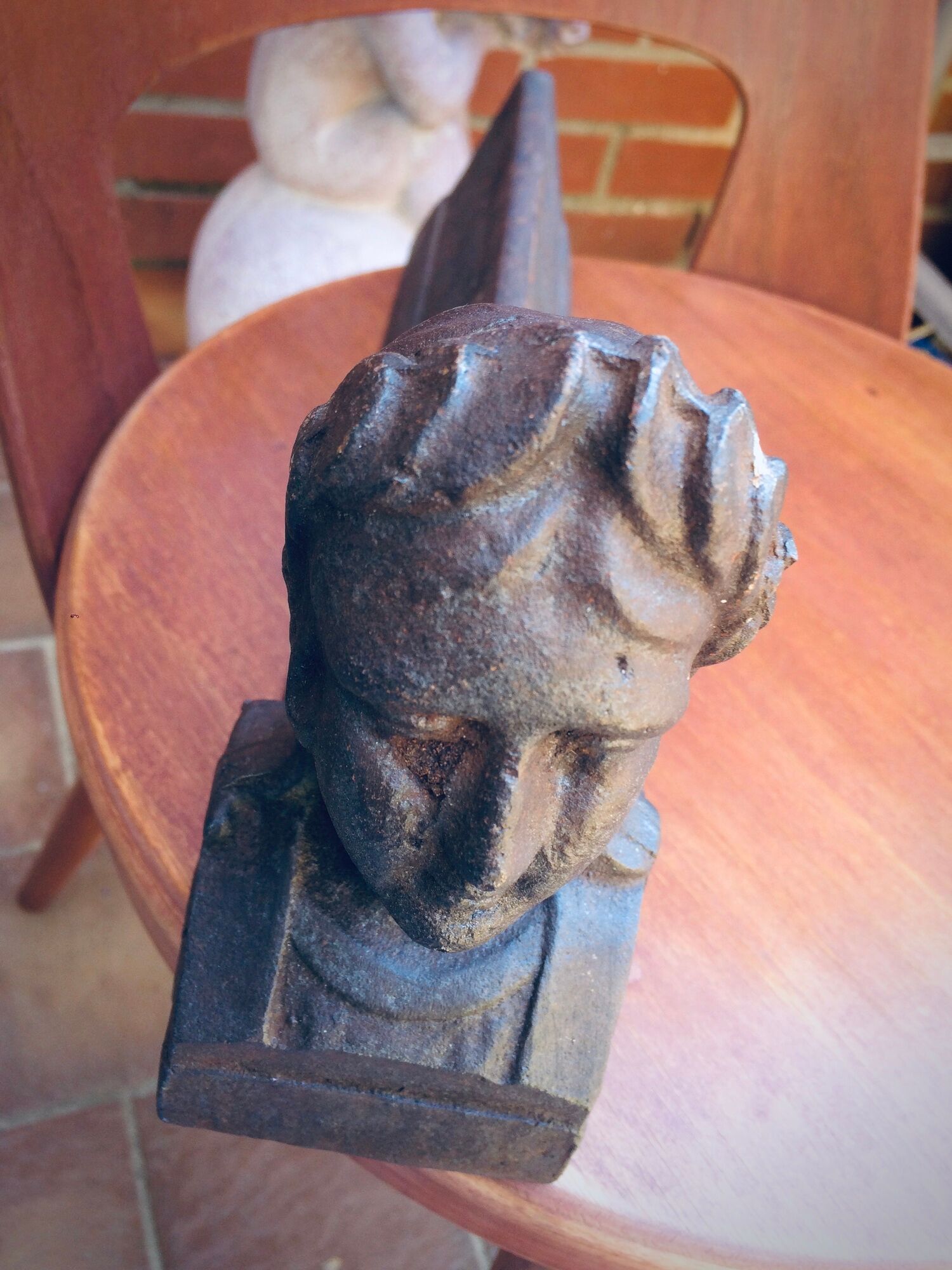 Pair of cast-iron chenet characters with laurels