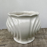 White ceramic pot cache in old flower slip