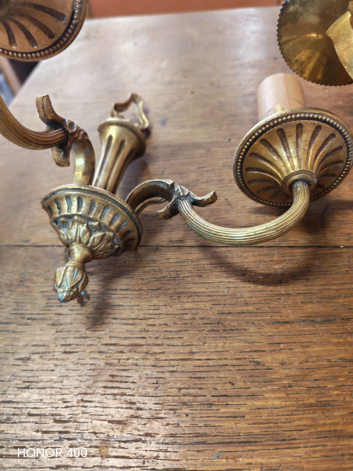 Two antique wall sconces in gilded bronze in the Louis XVI style.