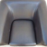 2 club armchairs with a chocolate faux leather seat and backrest and wooden legs.