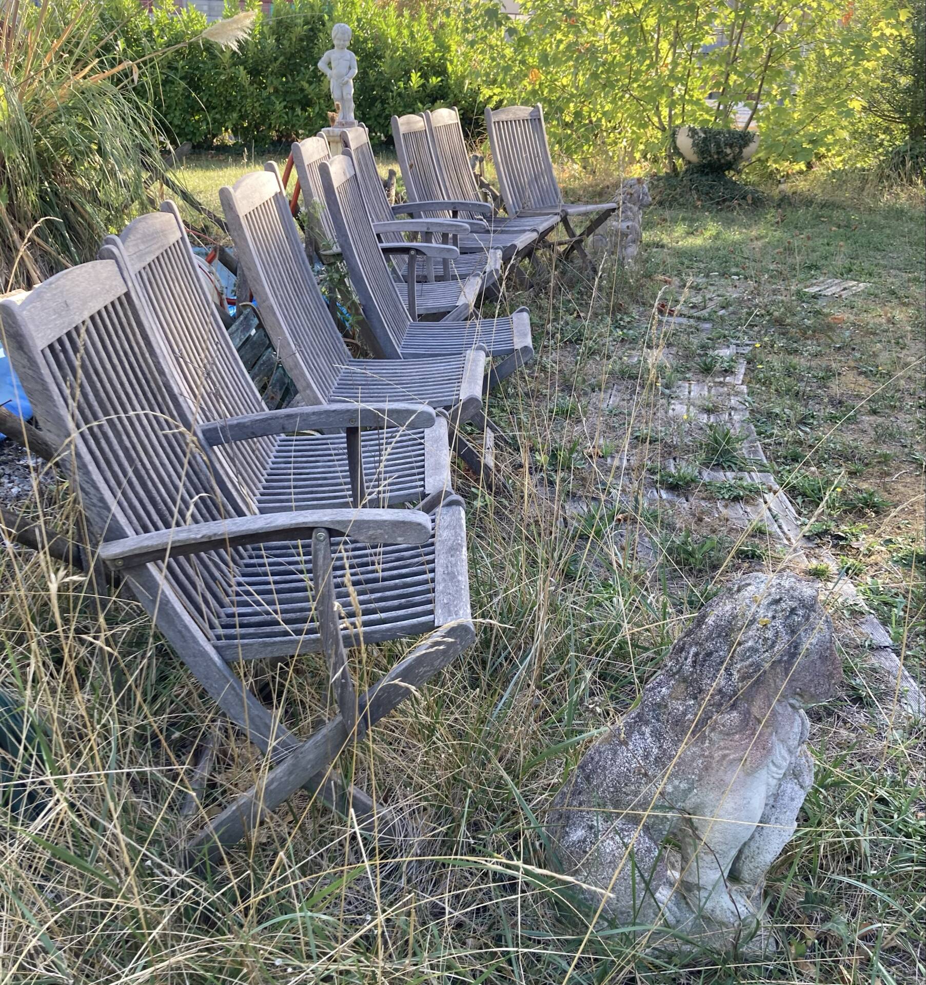 Folding garden chairs and armchairs in River Han dowelled teak.