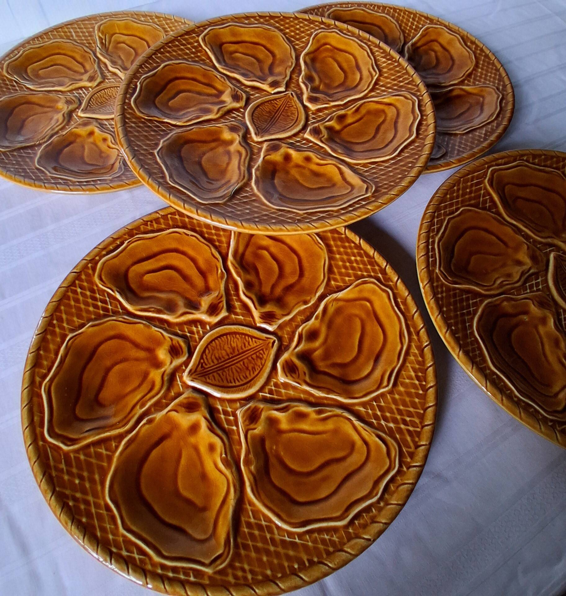 5 oyster or brown shell plates in good condition