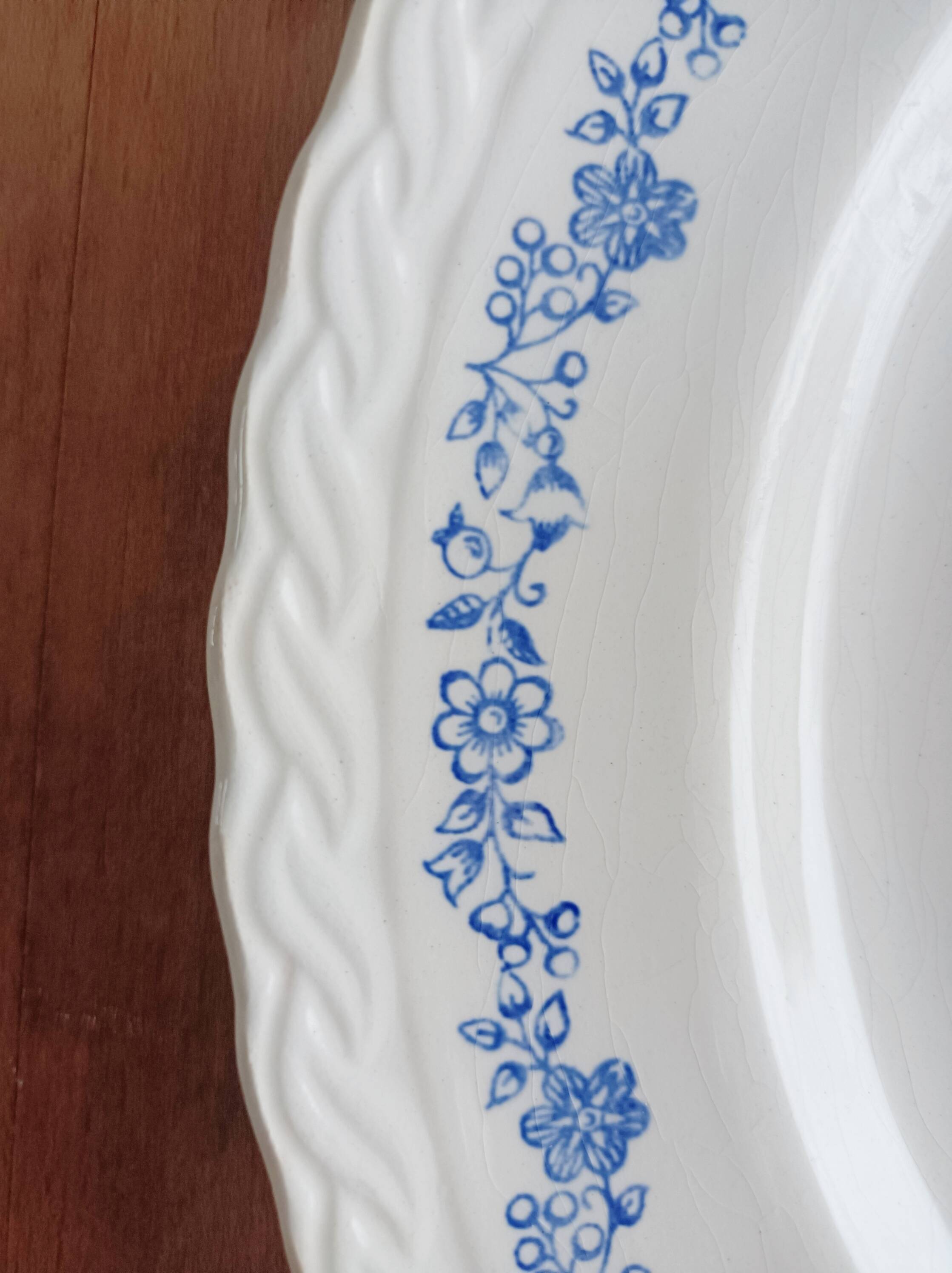 Round antique earthenware dish with floral decoration