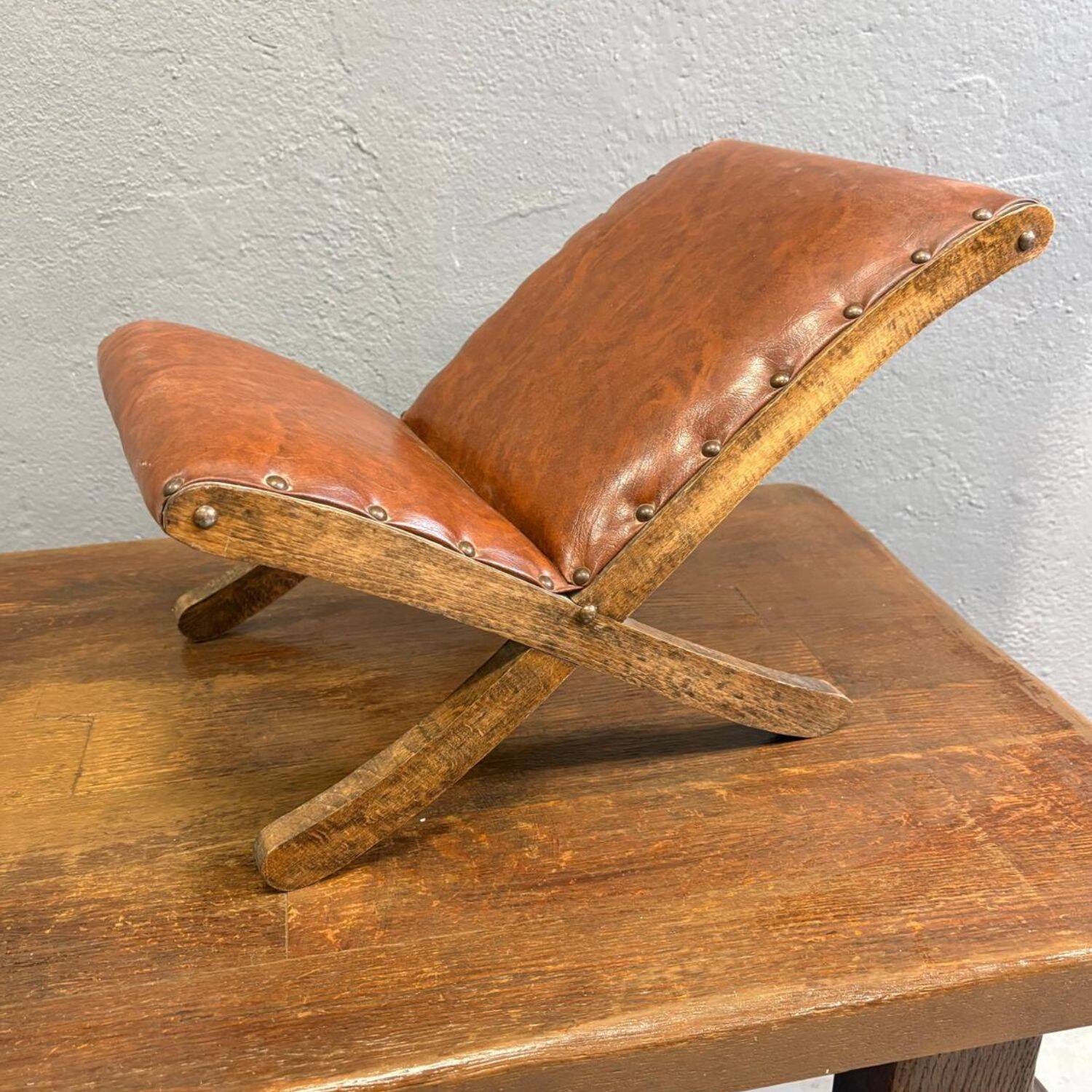 Old retro footstool, mid-century wooden leather stool, mid 20th century, European