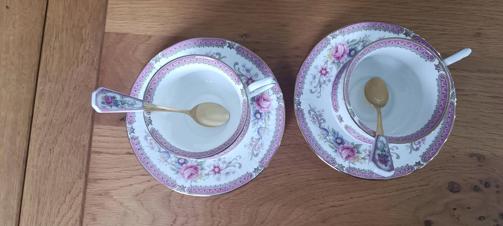 Duo of English porcelain tea cups from Queen's Richmond and spoons.