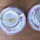 Duo of English porcelain tea cups from Queen's Richmond and spoons.
