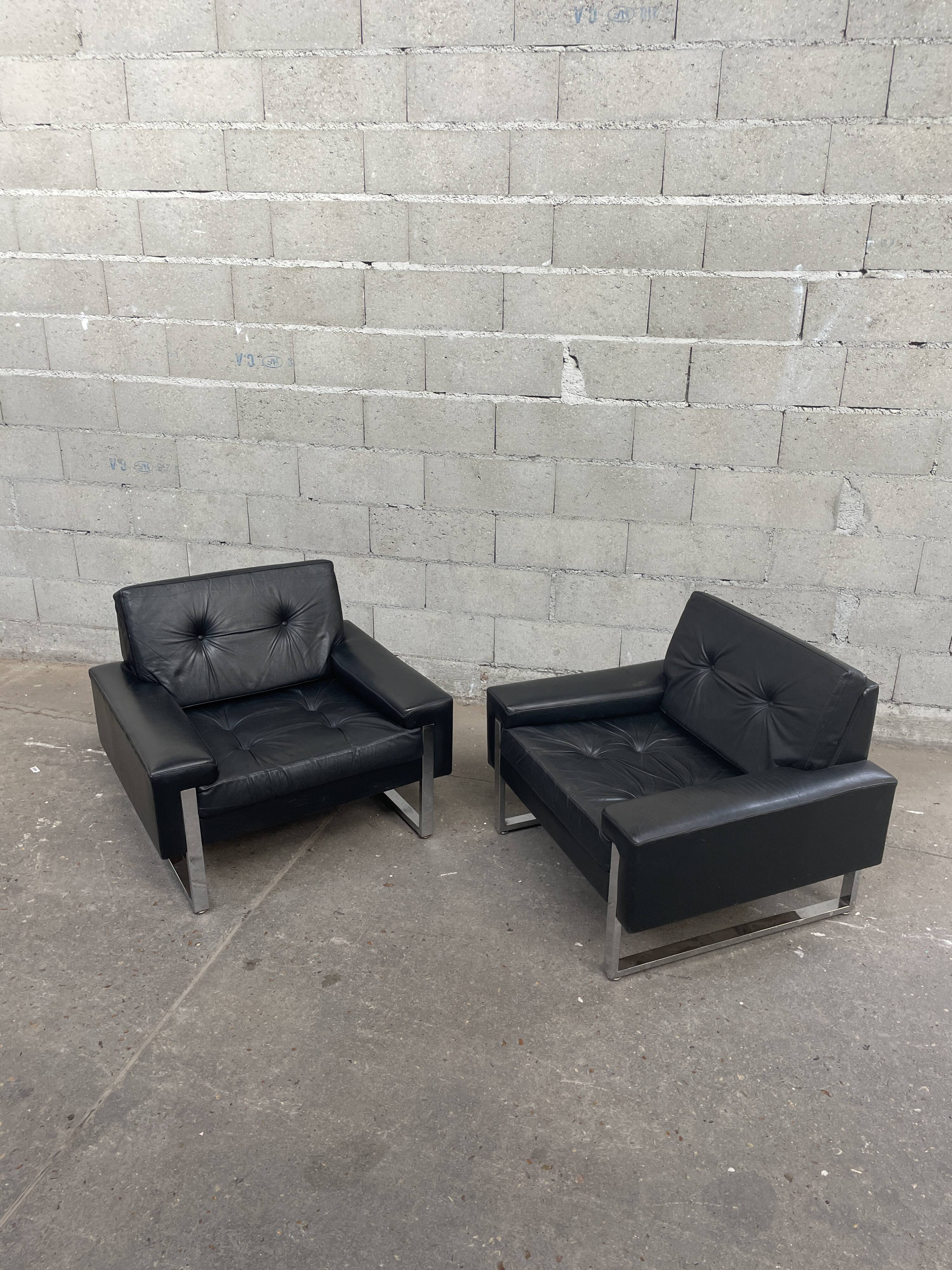 Pair of black leather armchairs